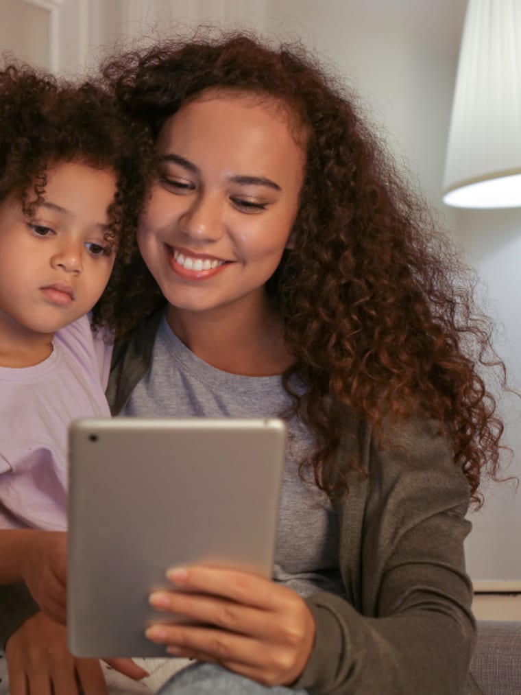 A parent and child learning together at home